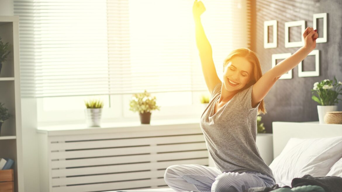 Women on bed stretching in the morning after getting up early