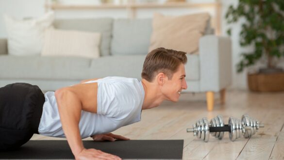 Man perfroming a burpee exercise in his home